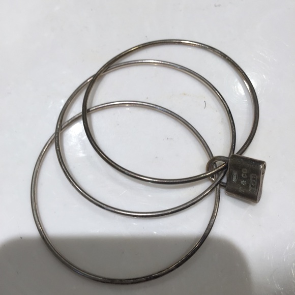 Tiffanys three bangle bracelet with locket.