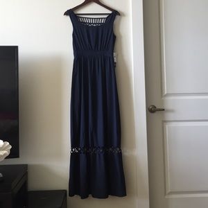 Navy blue maxi dress with crisscross cutouts.