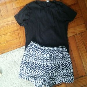 Black shirt and tribal pattern shorts