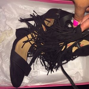 Black double fringe sandal heels.