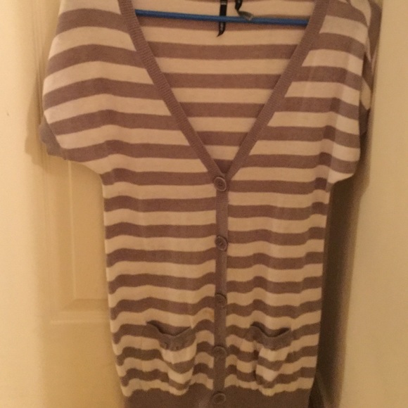 a grey and white shirt sleeves sweater