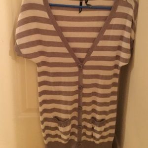 a grey and white shirt sleeves sweater