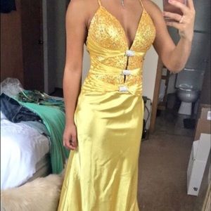 Yellow rhinestone embellished cut out prom dress.