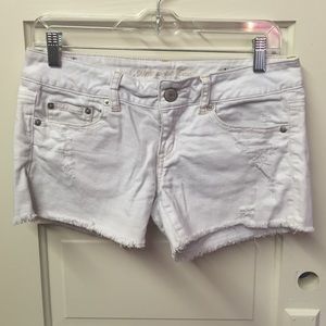 White deconstructed jean shorts.