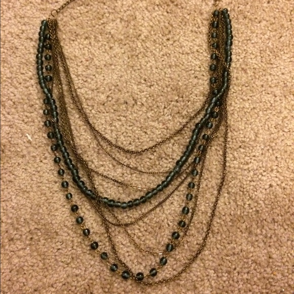 Multi-strand bead and brass necklace.