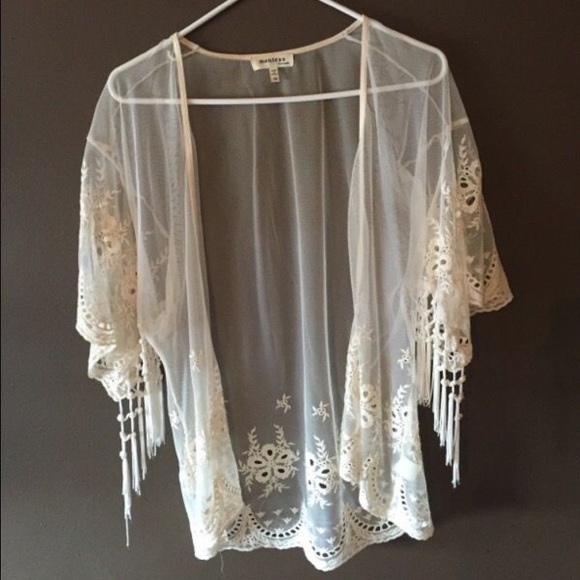 A lace cardigan , see through , off white color