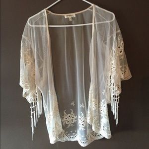 A lace cardigan , see through , off white color