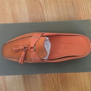 Orange Cole Haan Mules.