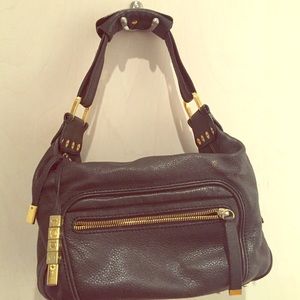 Black leather Tods handbag with gold details.
