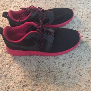 Pink and black Roshe runs