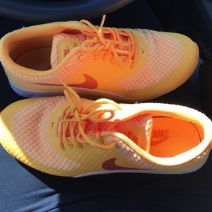 Orange and white nike air maxs