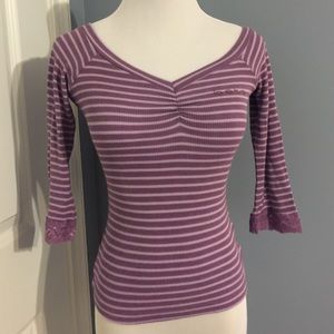 Purple stripped bebe rhinestone logo top.
