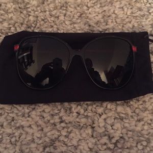 Gucci black sunglasses with red sidings