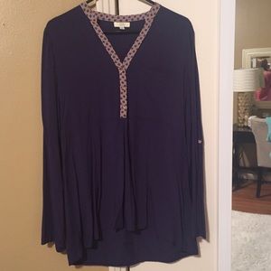 Blue blouse with details around the neck