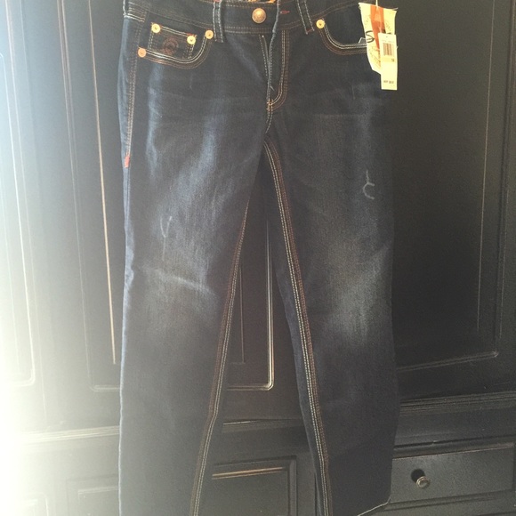 Dark colored Seven7 jeans.