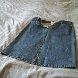Knee length denim type skirt. Medium to dark wash