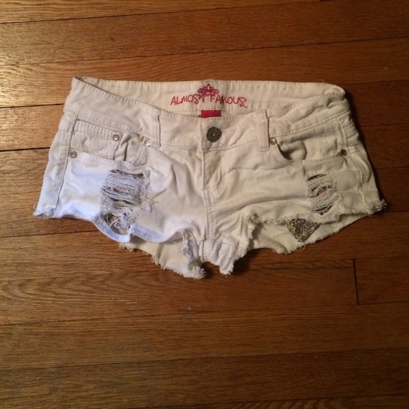 White jean shorts with floral pockets