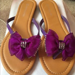 Purple bow tie flip flops