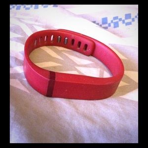 Red FitBit with charger