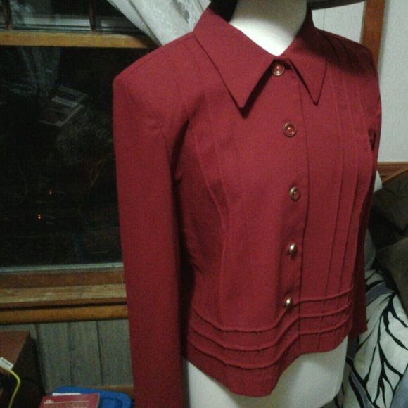 Red jacket with buttons in front.