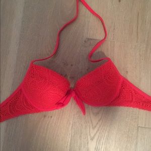 Red bikini top with crochet and a tie in the front