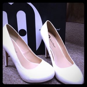 White patent leather pumps