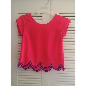 Vibrant pink scalloped blouse.