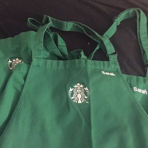4 Starbucks green aprons with the name "Sarah."