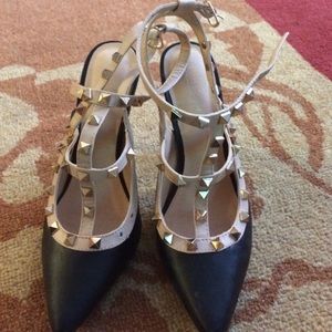 Black, Cream, and Gold Studded pumps.