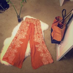 Free People orange gypsy flare pants.