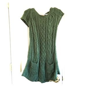 Green sweater dress with pockets.