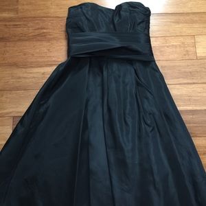 Black taffeta strapless dress.