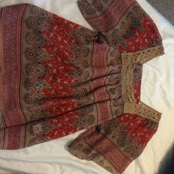 A tribal top with lace bordering around the neck