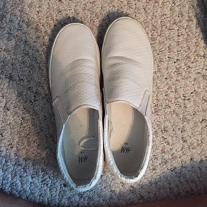 White snakeskin slip ons