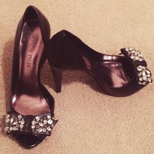 Black peep-toe pumps with rhinestone bow