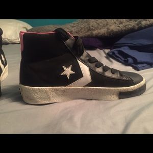 Pink and black high top converse
