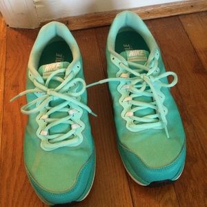 Turquoise Nike running shoes.