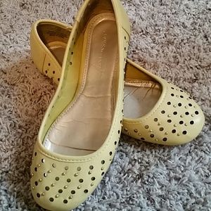 Yellow slip ons with gold balls and cut out circle