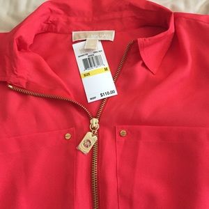 Silk shirt is coral in color