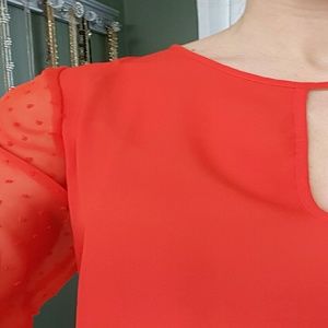 Bright orange/red blouse with embellished sleeves