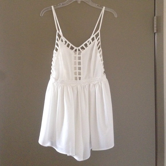 NWT white romper with cage and flower detail