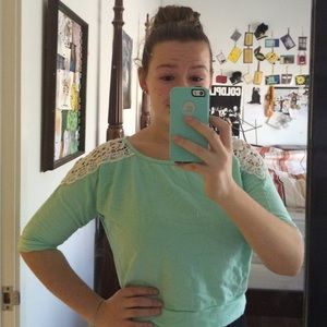 Mint green cropped sweater with lace shoulders.