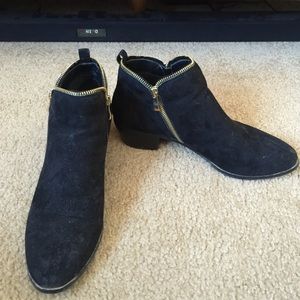 Black booties with gold zippers