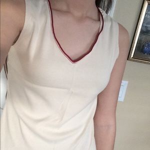 Creme colored shirt with red detailing