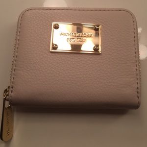 Cream colored small wallet.