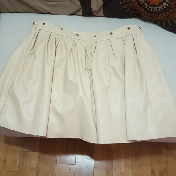 Pleated leater high waist skirt. Gold studs at top