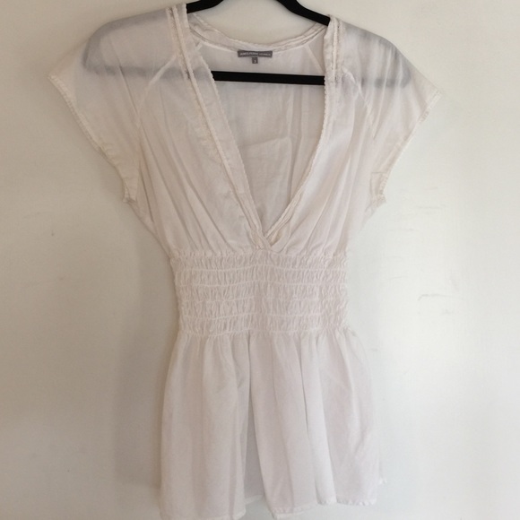 White cap-sleeve deep v-neck top.