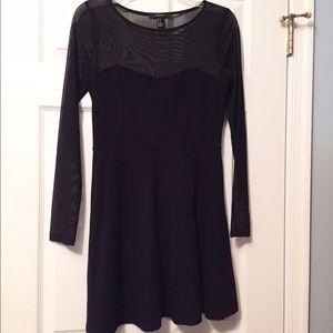 Black skater dress with sheer sleeves and neckline