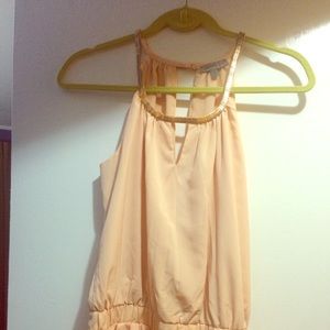 Peach jumper with a gold neck line trim