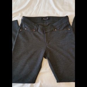 Grey leggings with faux black leather trim.